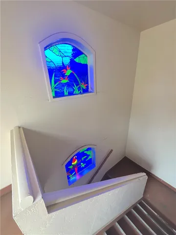 a view of a patio with furniture and a garden