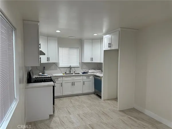a kitchen with a sink stove and refrigerator