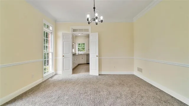 an empty room with a chandelier fan