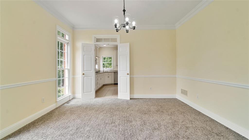 4612 Springside Court Southwest Mableton, GA 30126 - Photo 16 of 40 an empty room with chandelier and windows