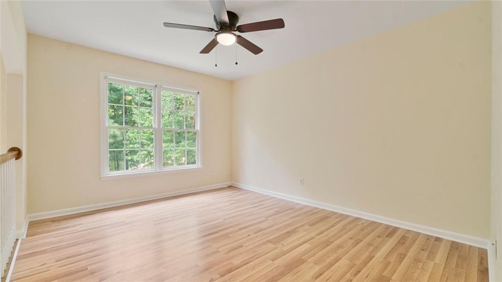 4612 Springside Court Southwest Mableton, GA 30126 - Photo 20 of 40 an empty room with wooden floor fan and windows