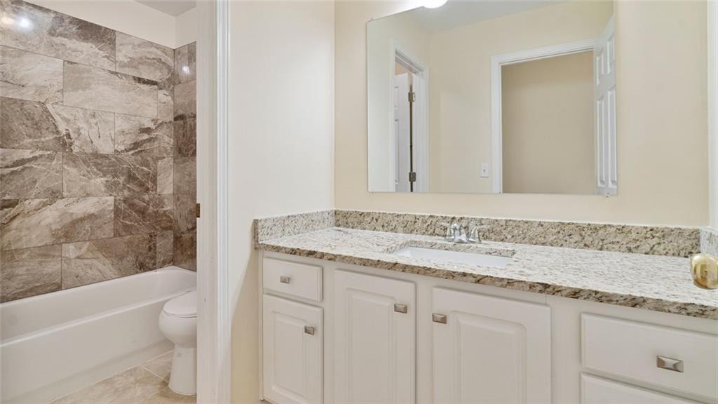 4612 Springside Court Southwest Mableton, GA 30126 - Photo 21 of 40 a bathroom with a granite countertop sink a toilet and bathtub