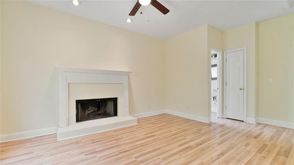 4612 Springside Court Southwest Mableton, GA 30126 - Photo 22 of 40 an empty room with wooden floor a fireplace