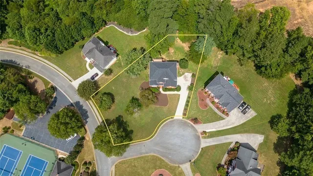 a backyard of a house with table and chairs