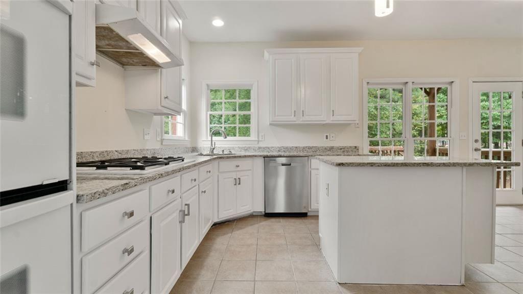 4612 Springside Court Southwest Mableton, GA 30126 - Photo 10 of 40 a kitchen with granite countertop white cabinets and a stove