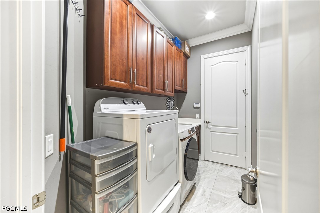 1700 43rd Terrace Southwest Naples, FL 34116 - Photo 26 of 38 a utility room with dryer and washer