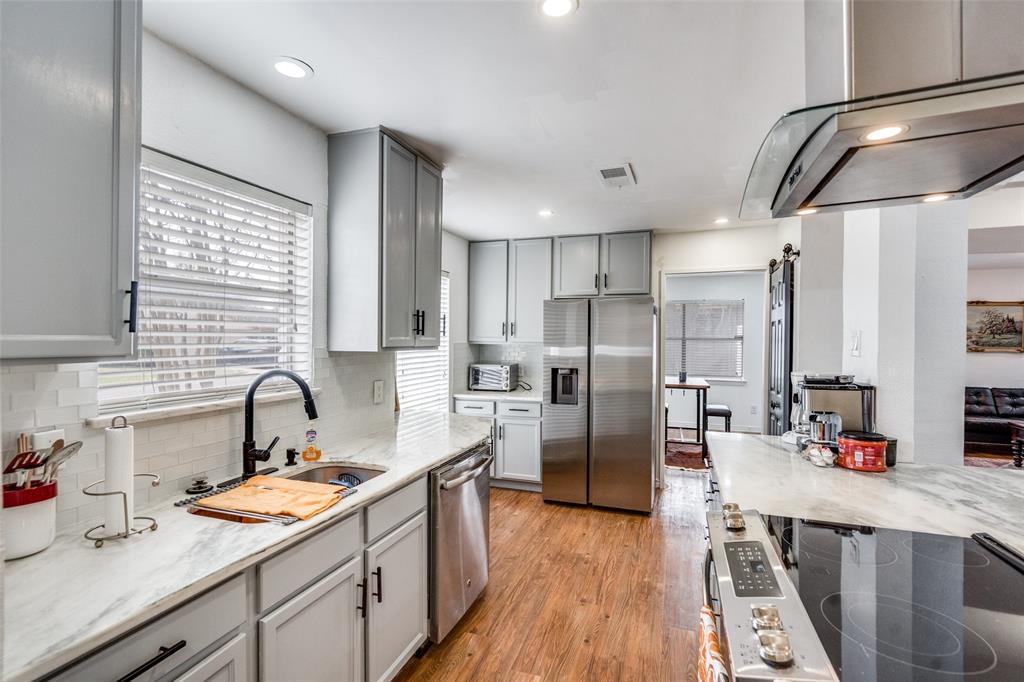 15642 Overmead Circle Dallas, TX 75248 - Photo 5 of 24 a kitchen with refrigerator cabinets and wooden floor