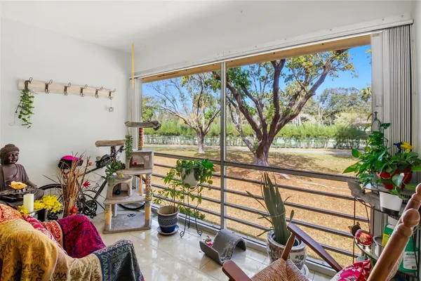 a bathroom with a granite countertop toilet sink and mirror