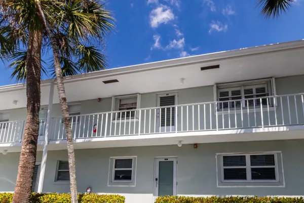 a kitchen with a sink refrigerator and cabinets