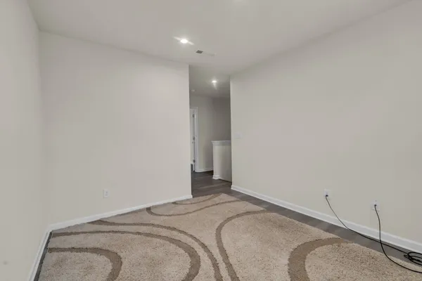 a bedroom with a bed and a lamp