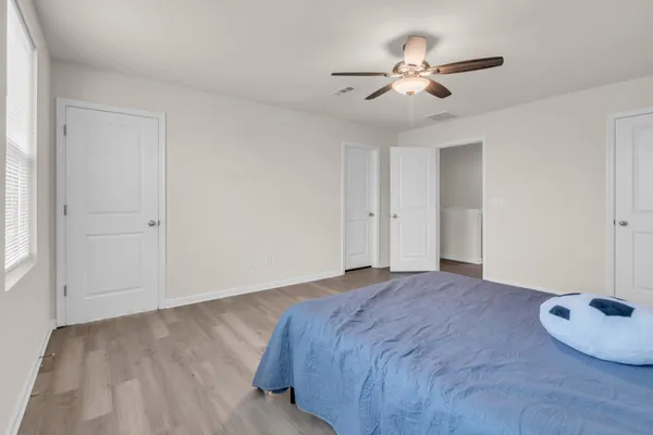 a view of a livingroom with a ceiling fan and window