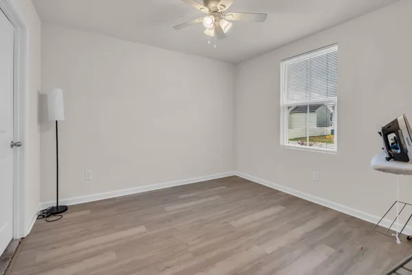 wooden floor in an empty room with a window