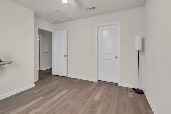 a view of an empty room with wooden floor
