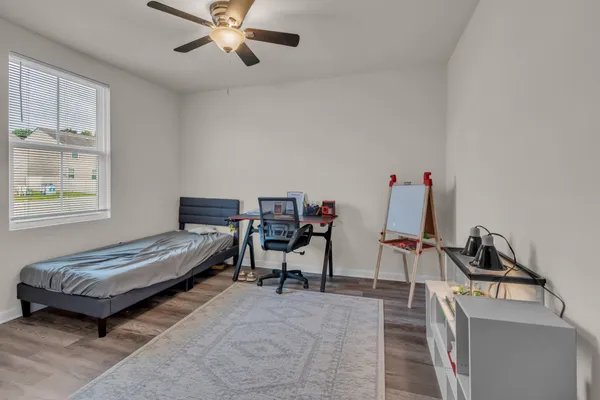 a bedroom with furniture and a window