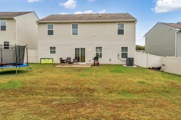 a view of a house with backyard and sitting area