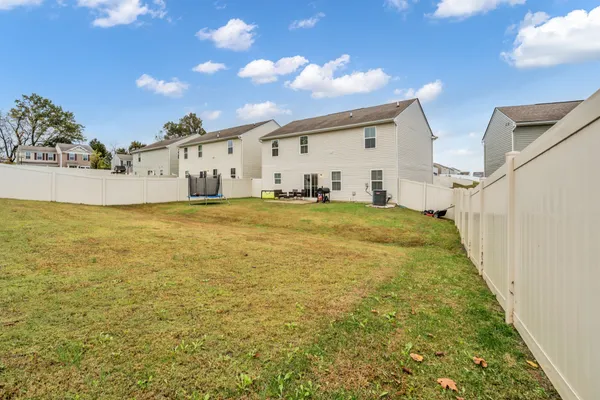 a view of a swimming pool with an outdoor seating and a yard