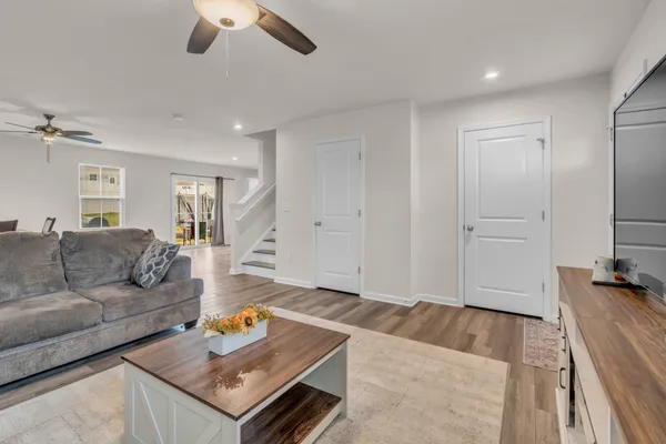 a living room with furniture and a wooden floor