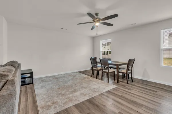 a view of a dining room with furniture and chandelier