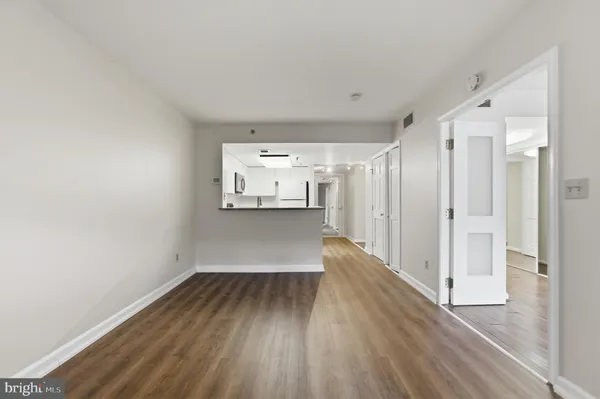 a view of a room with wooden floor and a window