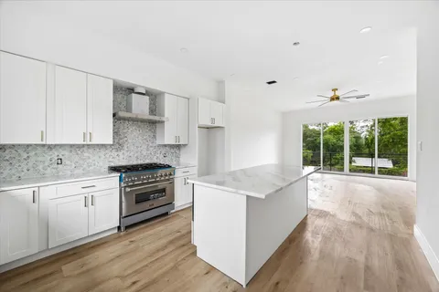 a kitchen with granite countertop a stove and a sink