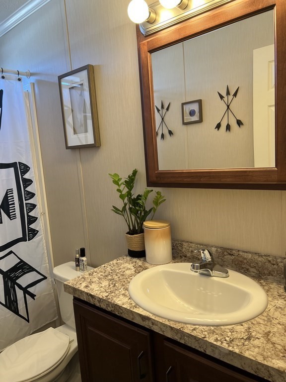 28 Grappone Drive Concord, NH 03301 - Photo 19 of 20 a bathroom with a granite countertop sink and a mirror