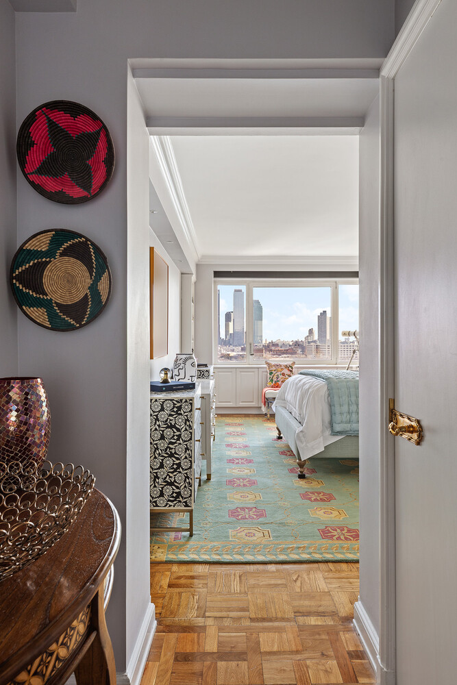 45 Sutton Place South, Unit 10H Manhattan, NY 10022 - Photo 10 of 18 a bedroom with a bed and a window