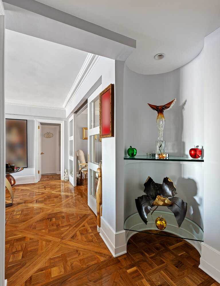 45 Sutton Place South, Unit 10H Manhattan, NY 10022 - Photo 9 of 18 a living room with furniture and a flat screen tv