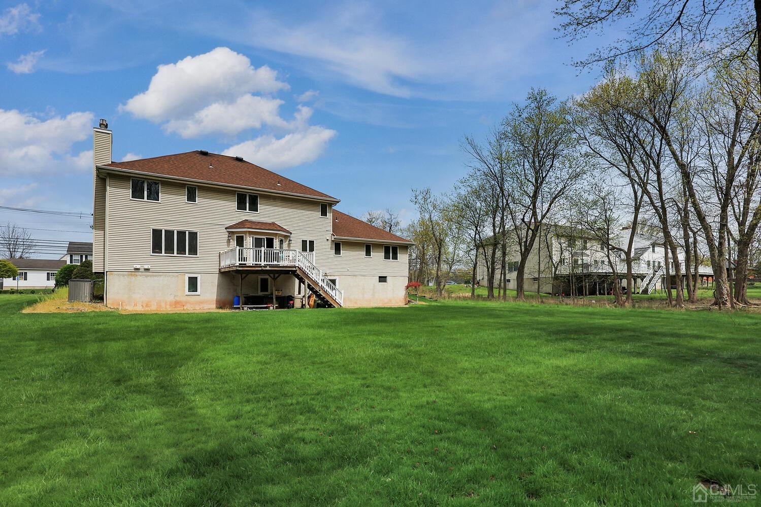 861 New Dover Road Edison, NJ 08820 - Photo 41 of 53 a white house that has a big yard with wooden fence