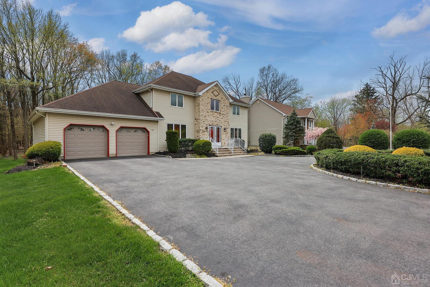 861 New Dover Road Edison, NJ 08820 - Photo 49 of 53 a front view of a house with a yard and garage