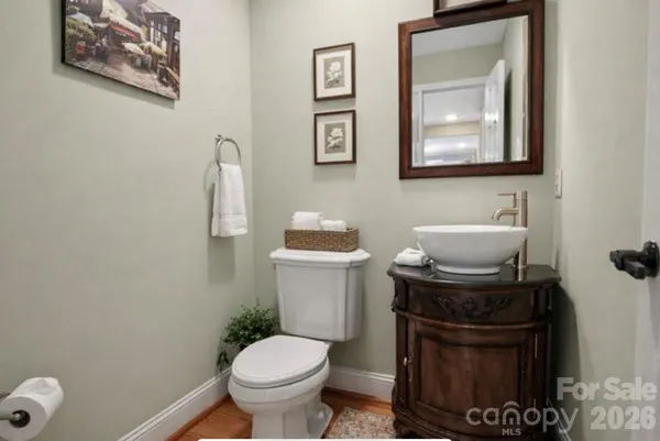 a bathroom with a toilet a sink and mirror