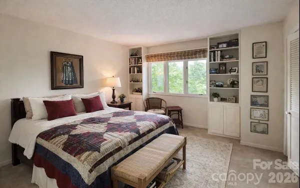 a bedroom with a bed and a window