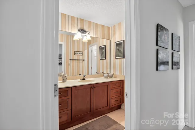a bathroom with a double vanity sink and a mirror