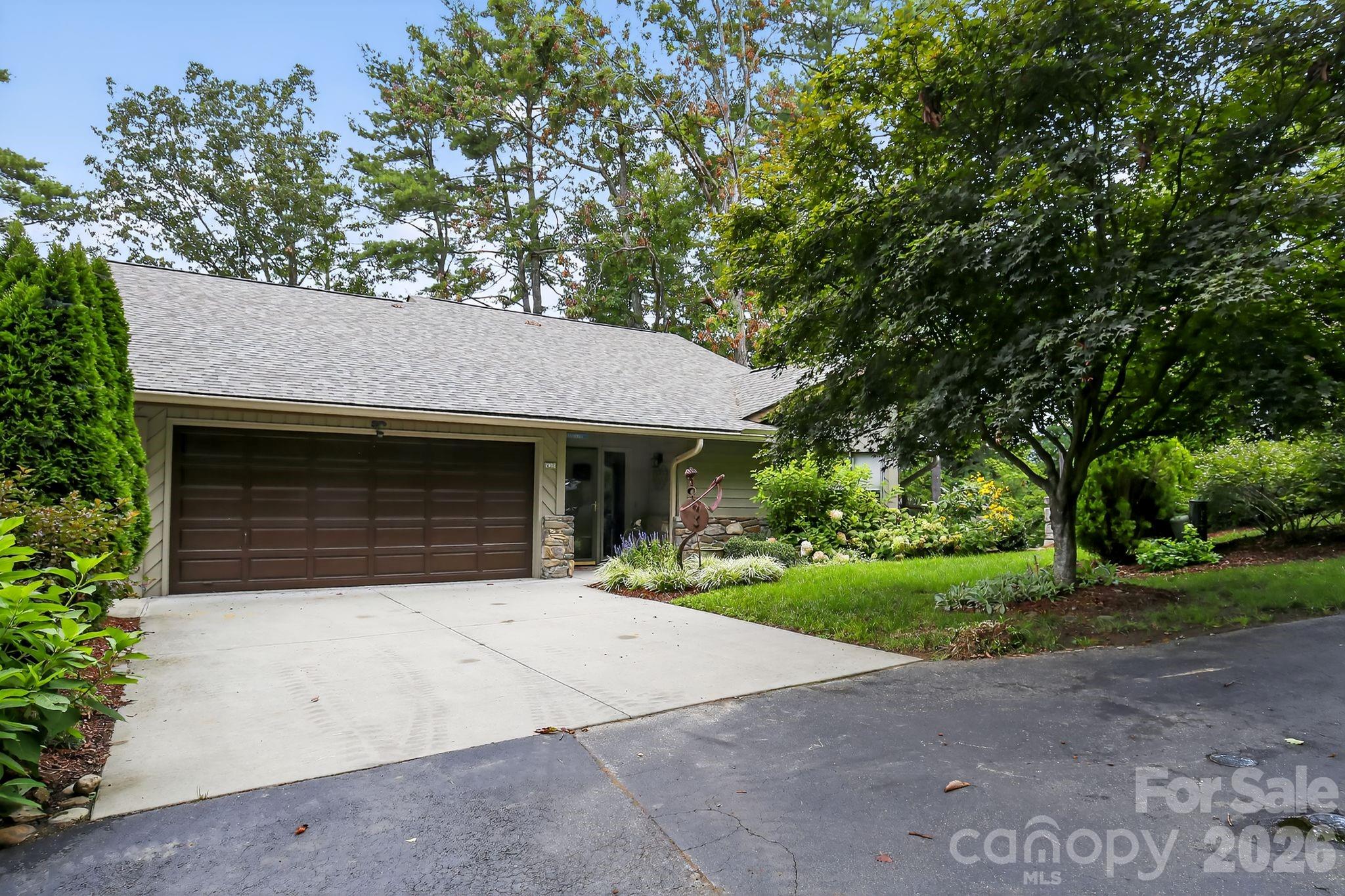 2902 Timber Trail Asheville, NC 28804 - Photo 16 of 16 a front view of a house with a garden