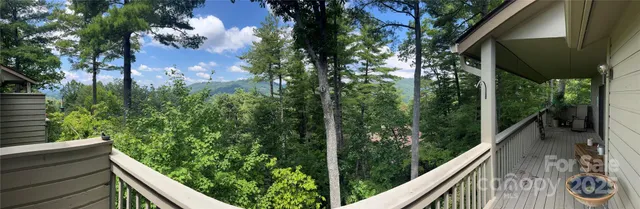 a view of a balcony with wooden fence and floor