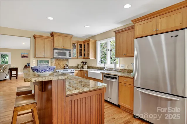 a kitchen with stainless steel appliances granite countertop a refrigerator sink and cabinets