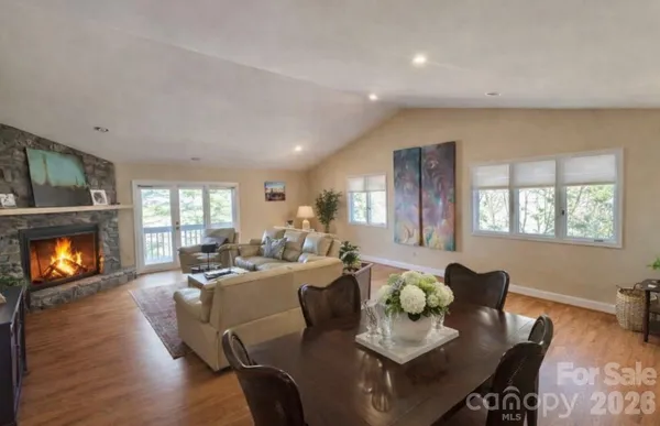 a living room with fireplace furniture and a wooden floor