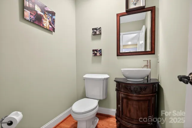 a bathroom with a toilet a sink and mirror
