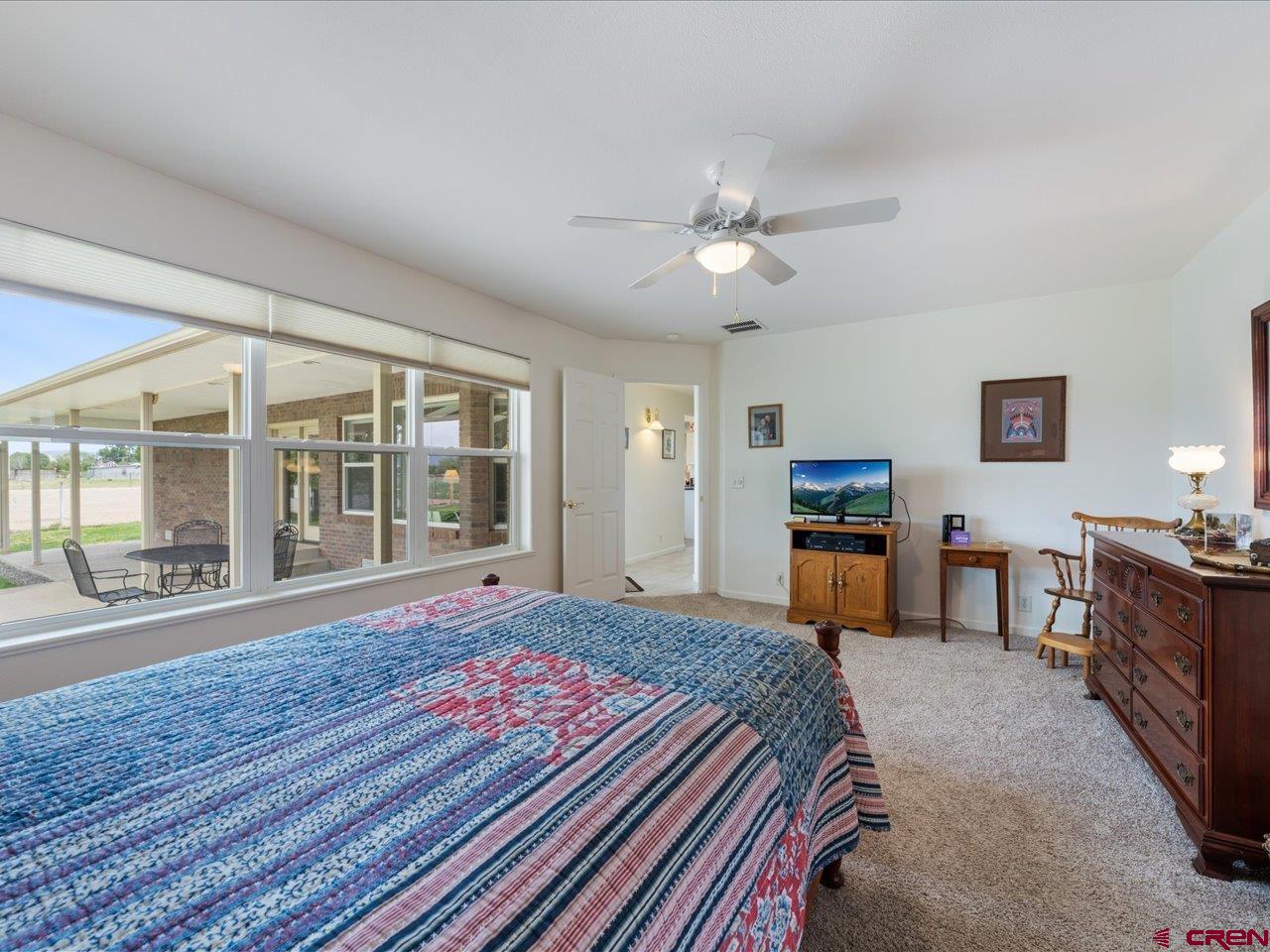 61611 Monroe Road Montrose, CO 81403 - Photo 20 of 35 a spacious bedroom with a bed and a large window