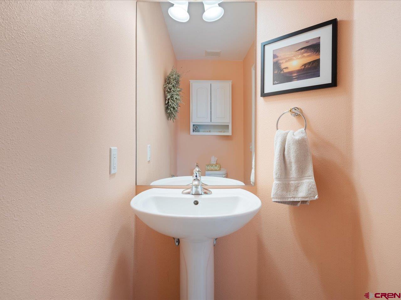 61611 Monroe Road Montrose, CO 81403 - Photo 25 of 35 a bathroom with a sink and a mirror