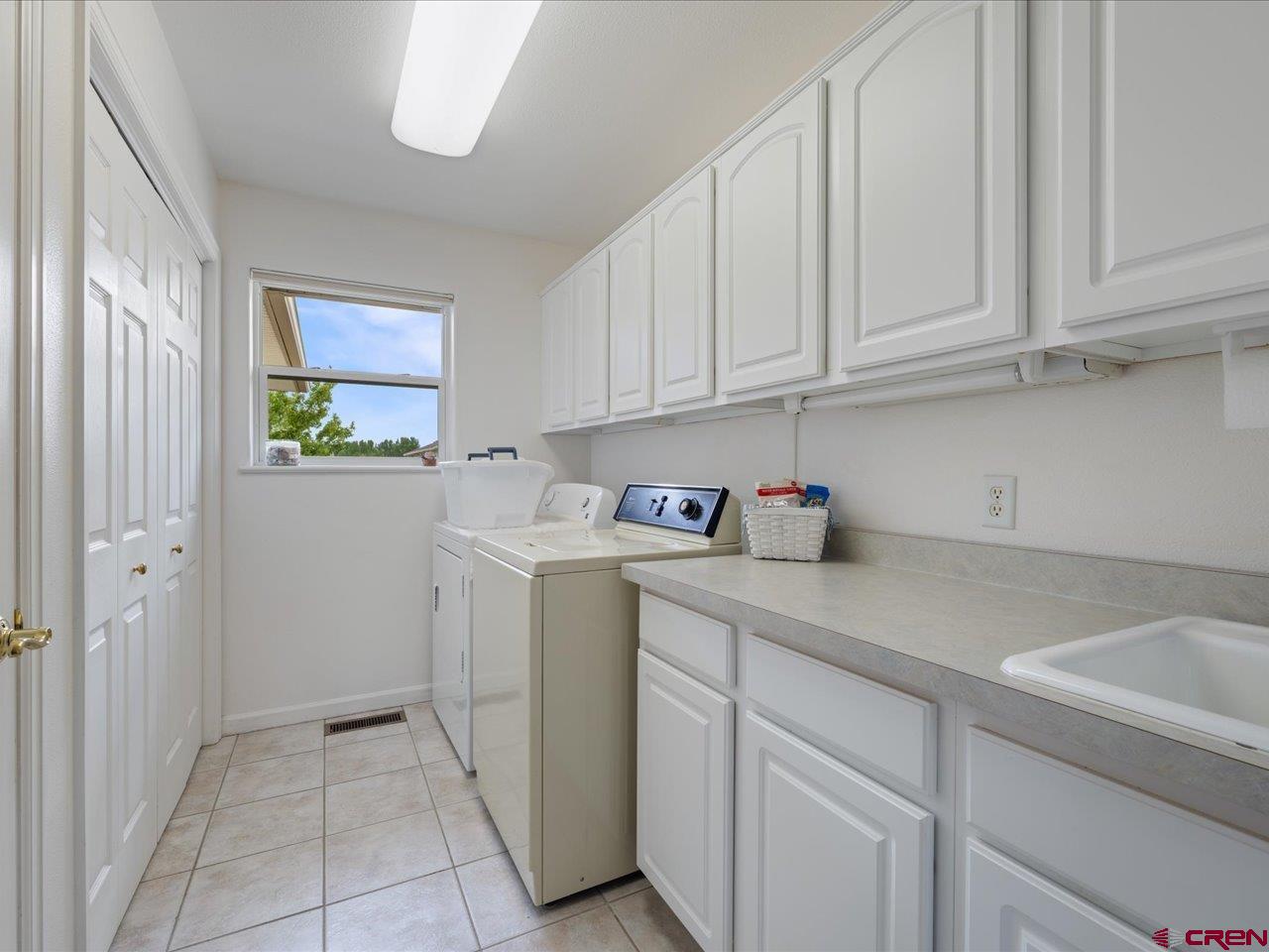 61611 Monroe Road Montrose, CO 81403 - Photo 26 of 35 a utility room with cabinets washer and dryer
