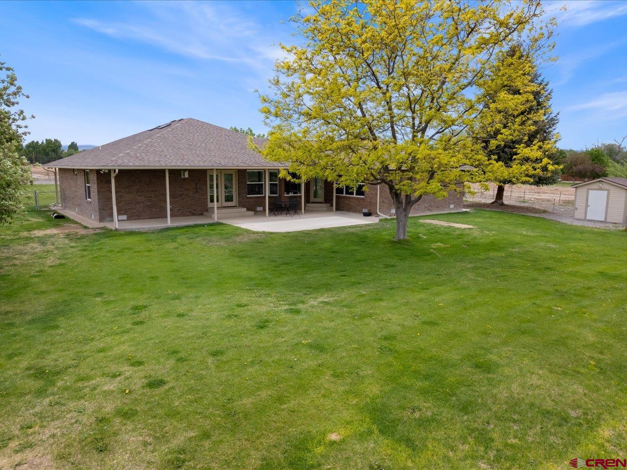 61611 Monroe Road Montrose, CO 81403 - Photo 3 of 35 a front view of a house with a garden