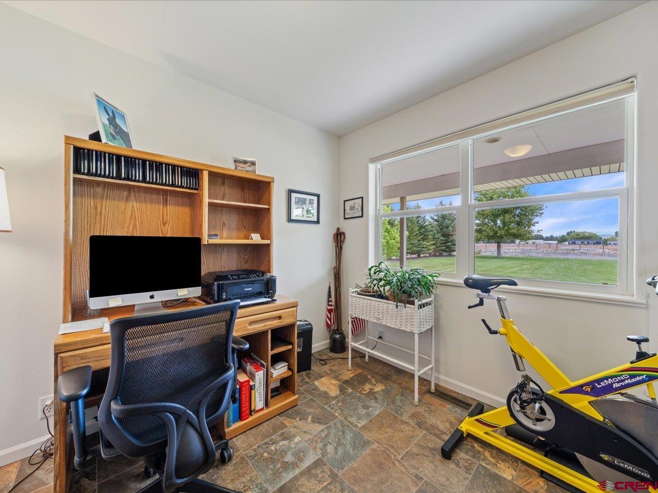 61611 Monroe Road Montrose, CO 81403 - Photo 7 of 35 a room with furniture and a flat screen tv