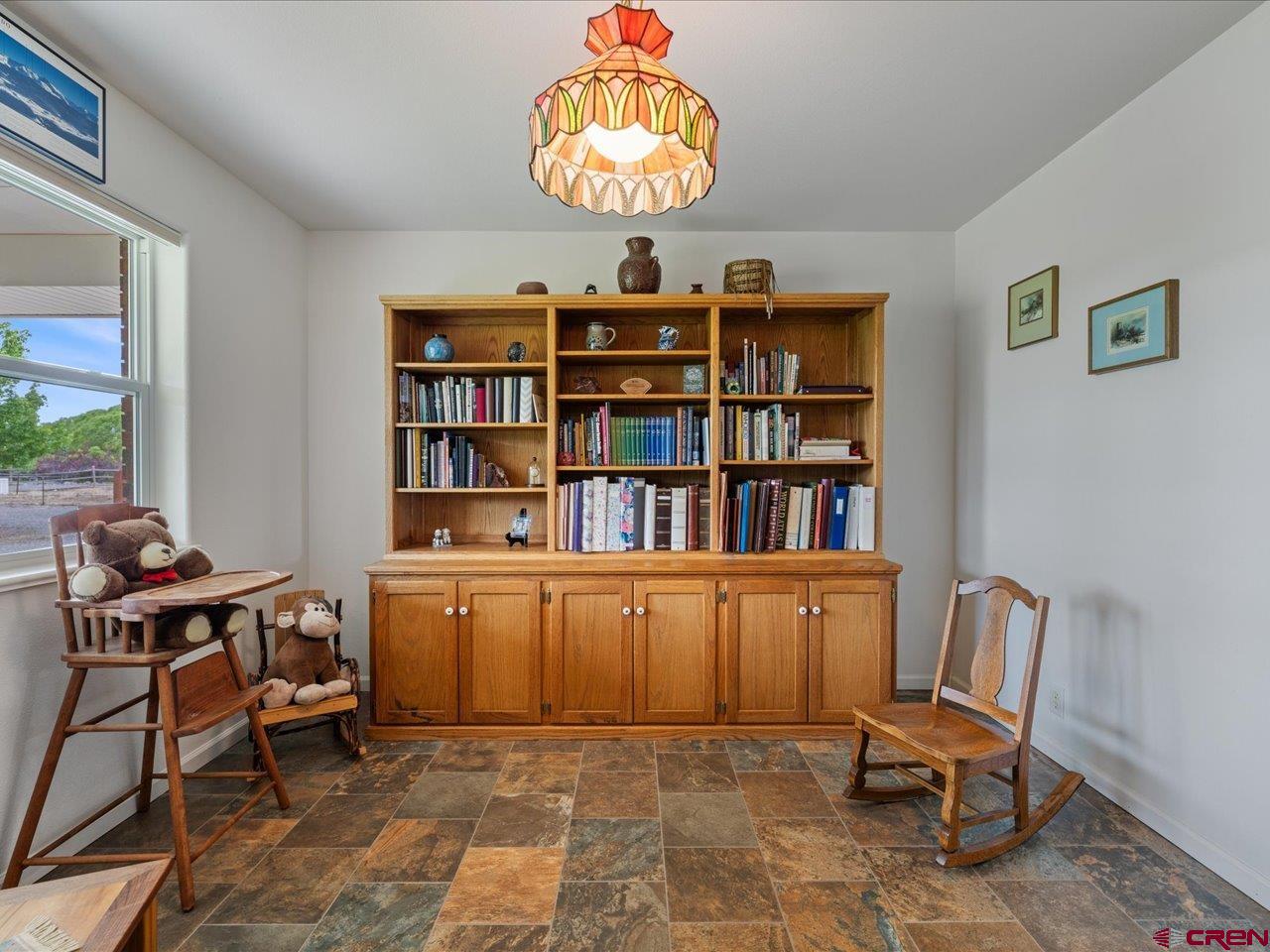 61611 Monroe Road Montrose, CO 81403 - Photo 9 of 35 a workspace with a bookshelf
