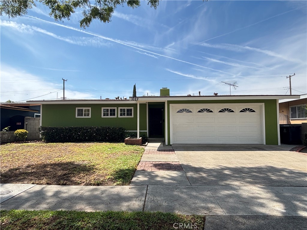 1022 Concord Street Santa Ana, CA 92701 - Photo 1 of 19 a front view of a house with a yard and garage