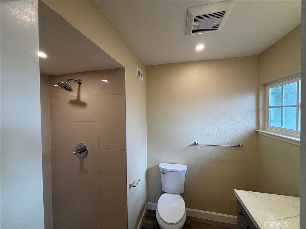 1022 Concord Street Santa Ana, CA 92701 - Photo 13 of 19 a bathroom with a toilet a sink and shower
