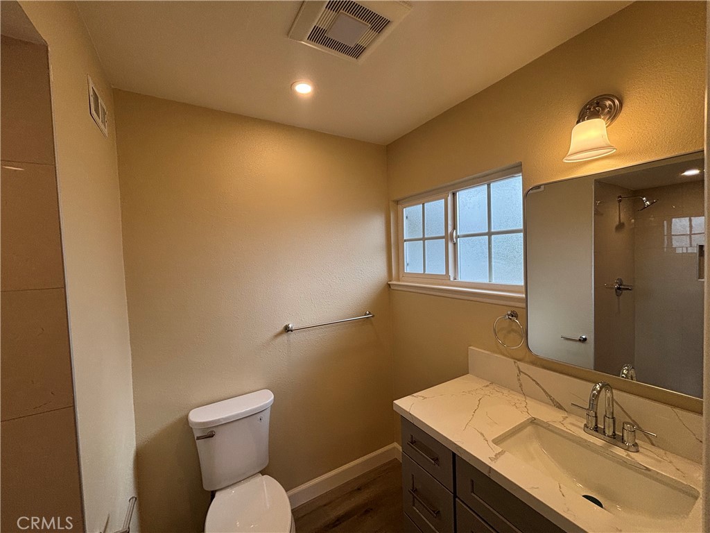 1022 Concord Street Santa Ana, CA 92701 - Photo 14 of 19 a bathroom with a sink vanity mirror and toilet