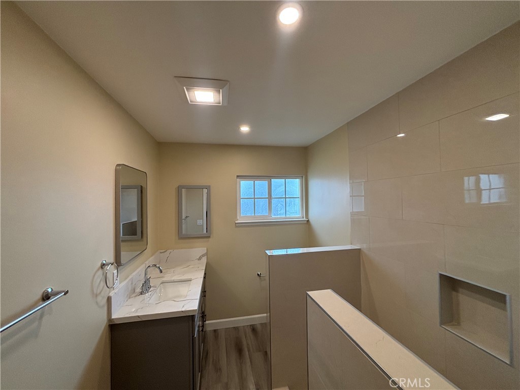 1022 Concord Street Santa Ana, CA 92701 - Photo 15 of 19 a bathroom with a sink a toilet and mirror