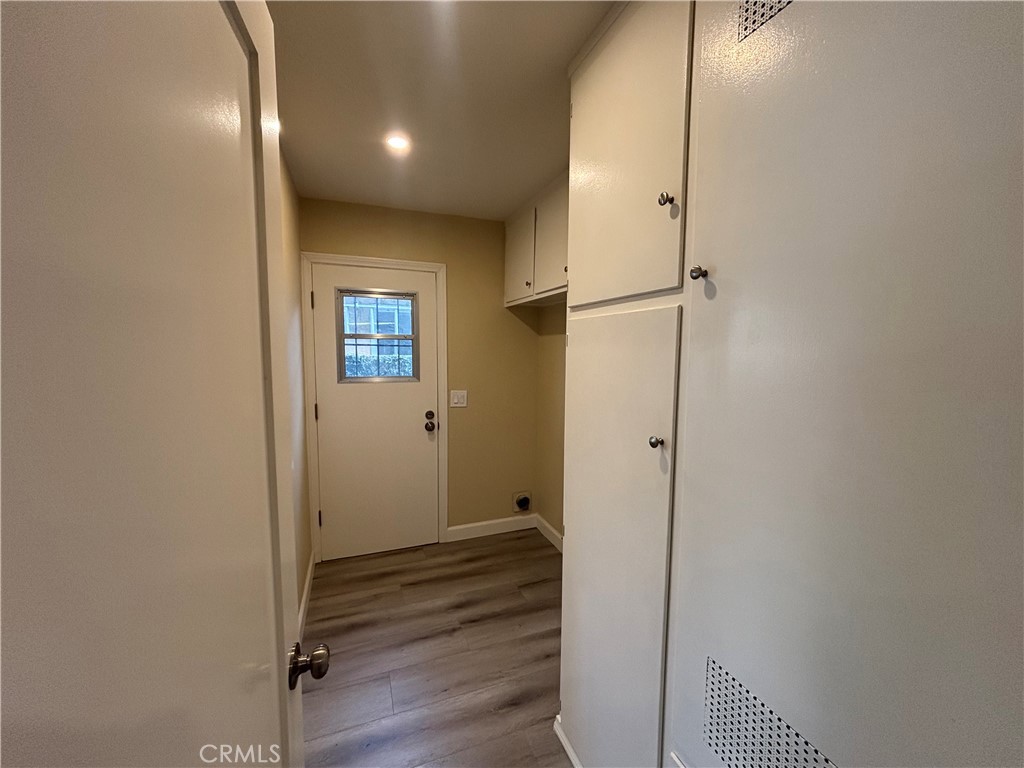 1022 Concord Street Santa Ana, CA 92701 - Photo 16 of 19 a view of a hallway with wooden floor and a bathroom