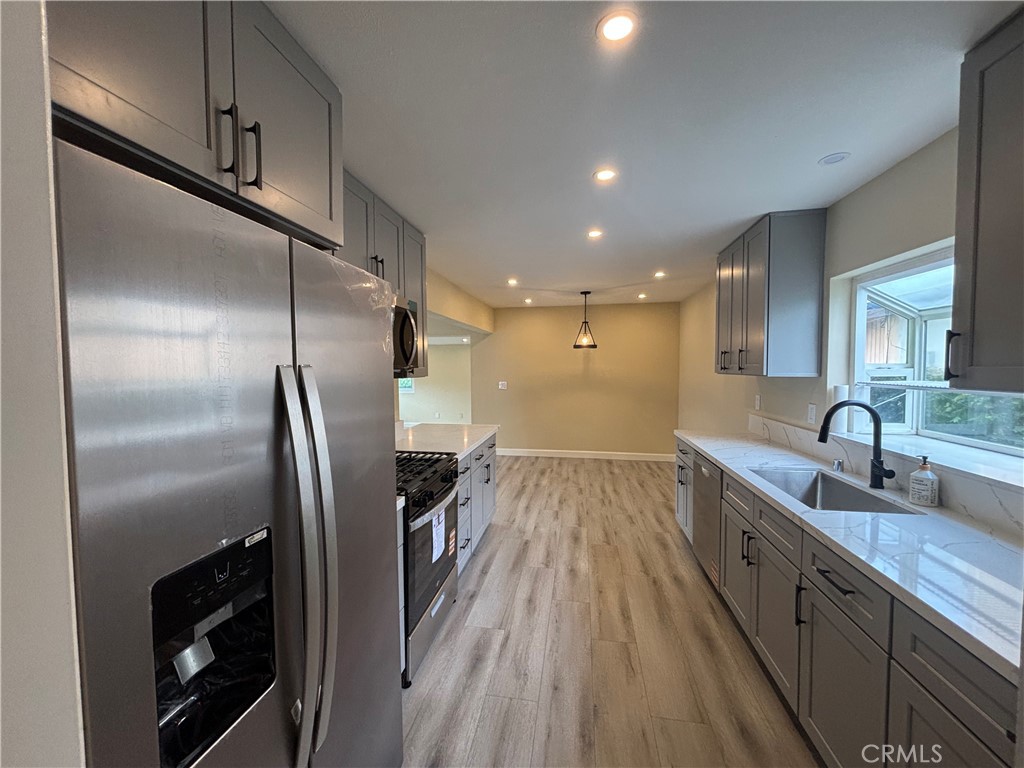 1022 Concord Street Santa Ana, CA 92701 - Photo 4 of 19 a kitchen with stainless steel appliances granite countertop a refrigerator a sink and a stove