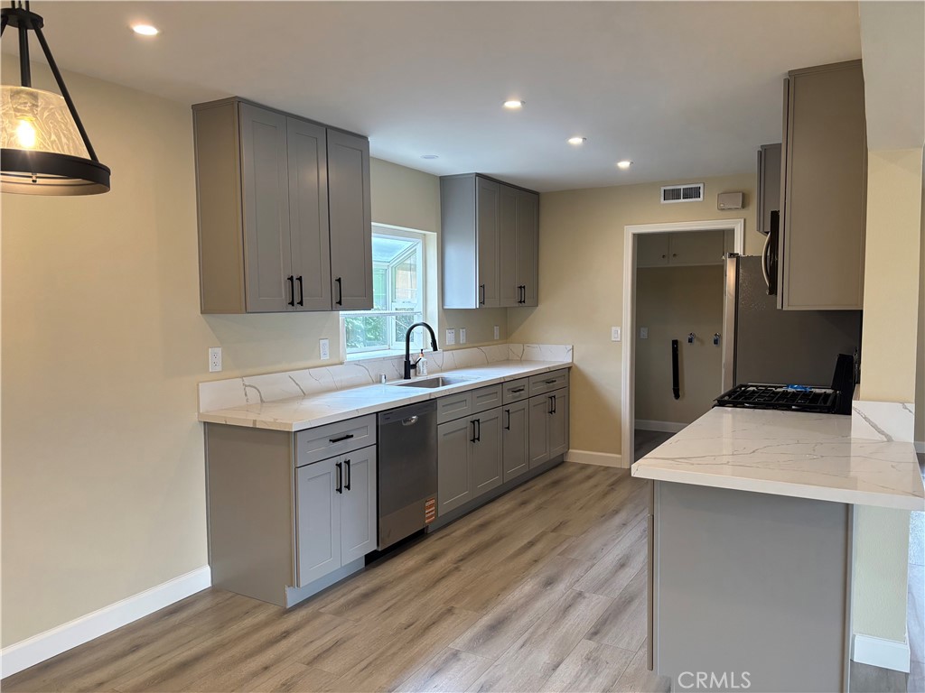 1022 Concord Street Santa Ana, CA 92701 - Photo 5 of 19 a kitchen with a sink cabinets and wooden floor